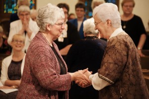 Sister Lois Eckes, former Prioress, offers the new Prioress her support