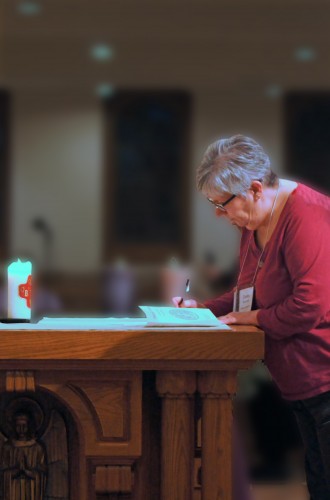 Person signing a paper on the altar