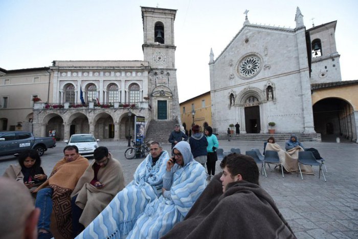 Norcia town square with people fleeing unstable buildings