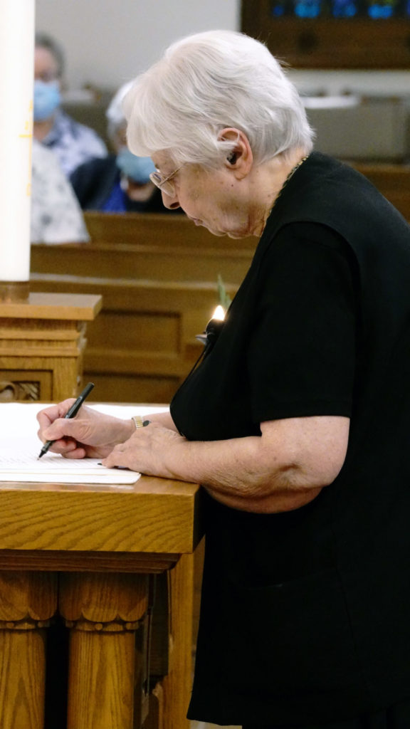 Sister Claudia Cherro signs her vows.
