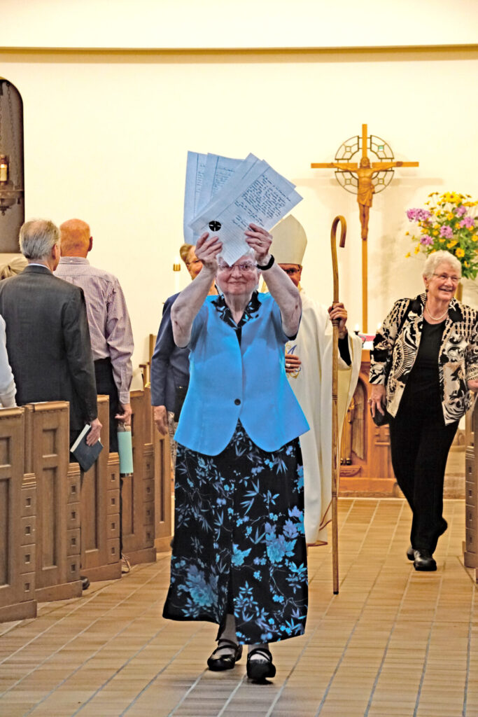 Sister Beverly Raway leads the recessional, holding the signed vows.