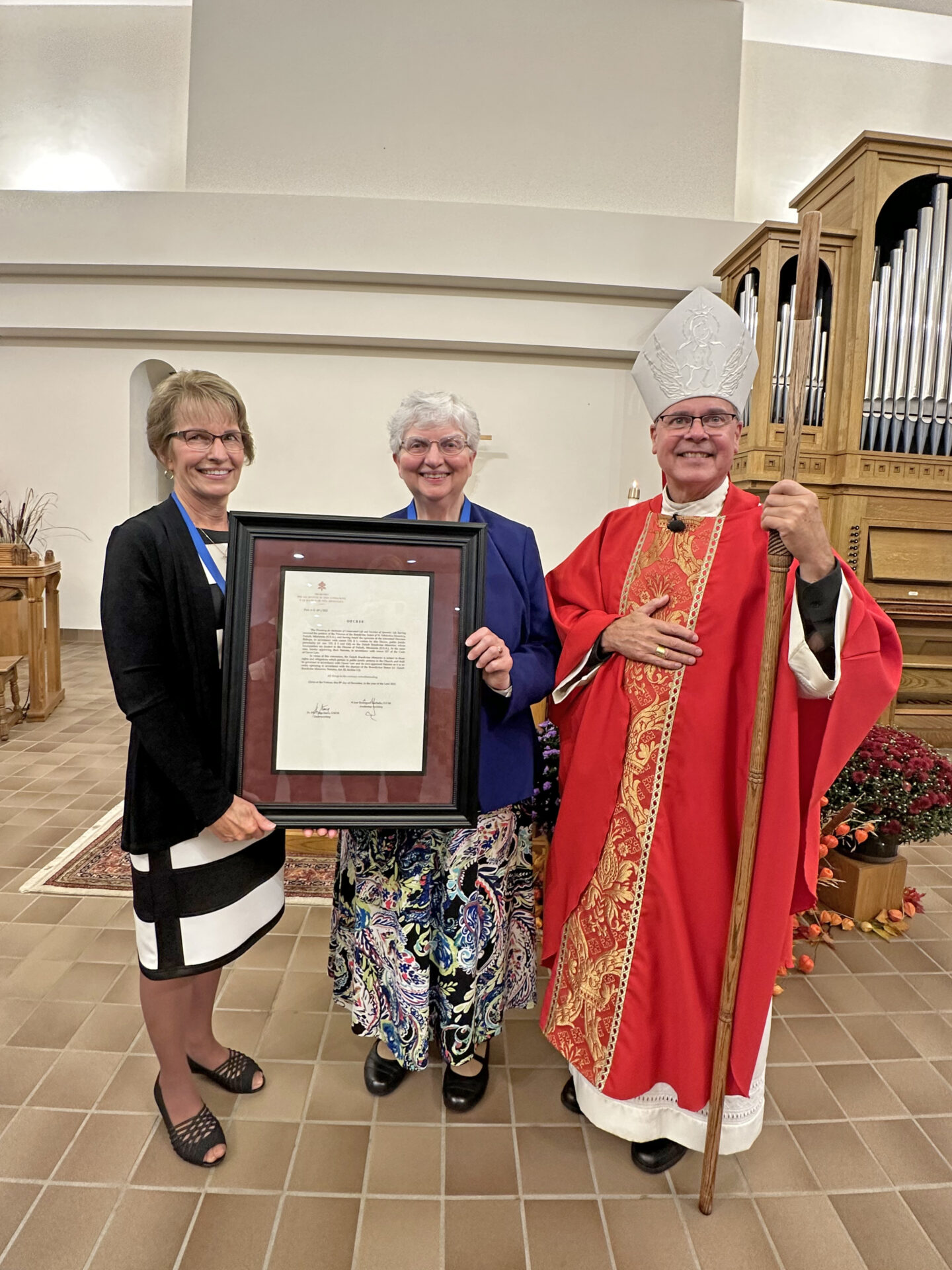Lori Collard, Sister Beverly Raway, and Bishop Daniel Felton with letter of approval from the Vatican