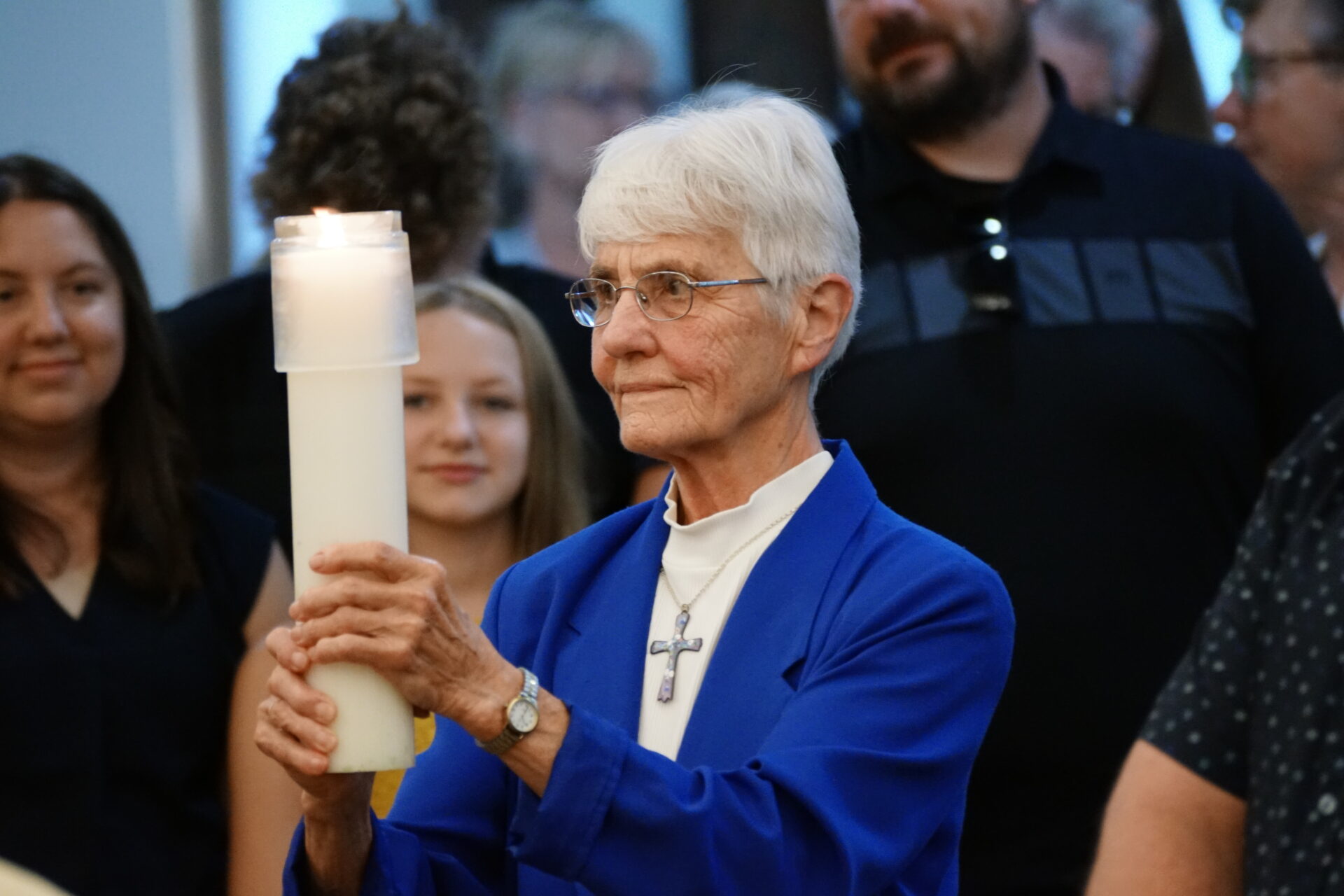 Sister Theresa Spinler carries the Paschal Candle